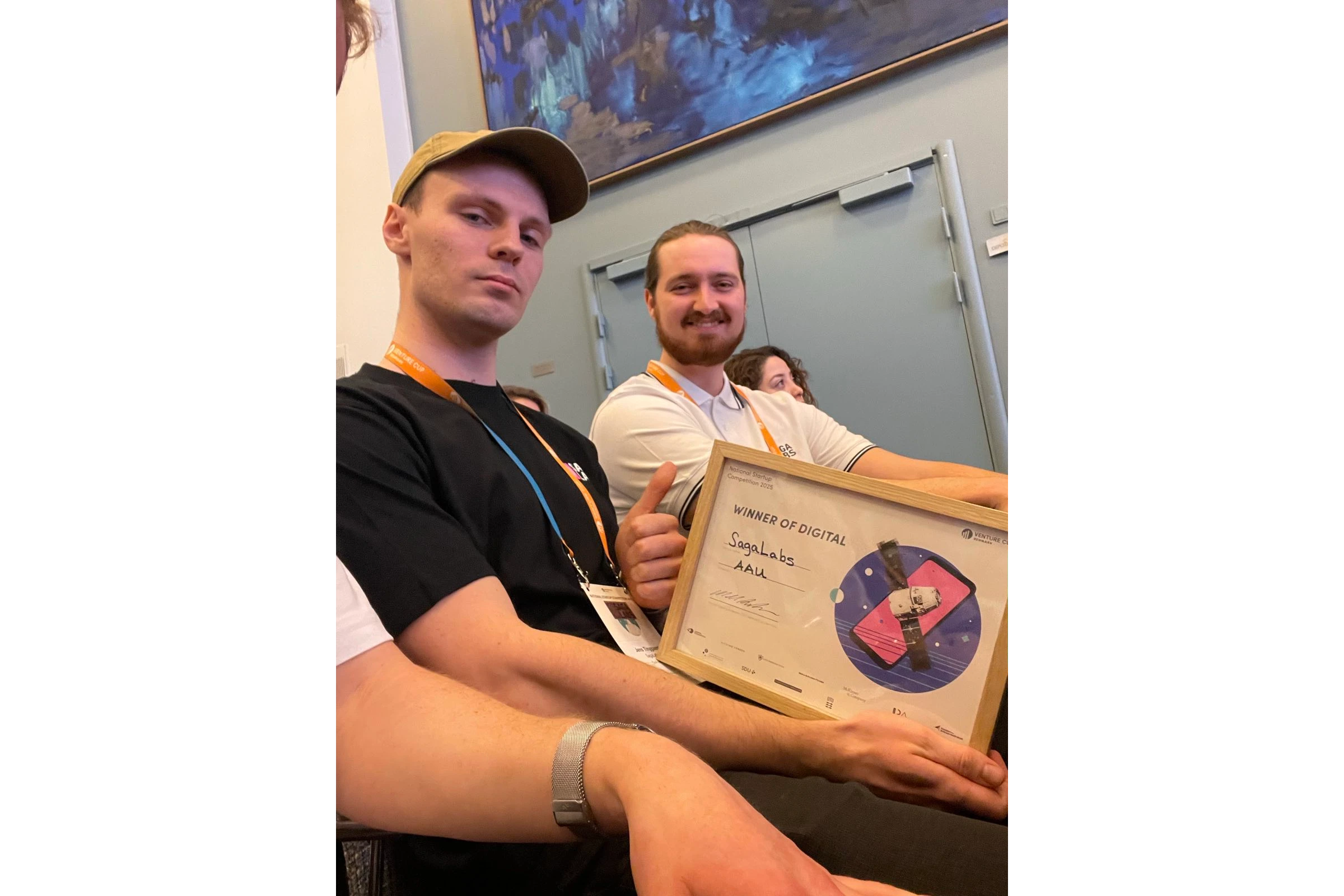 SagaLabs founders holding the Venture Cup semifinal digital winner certificate